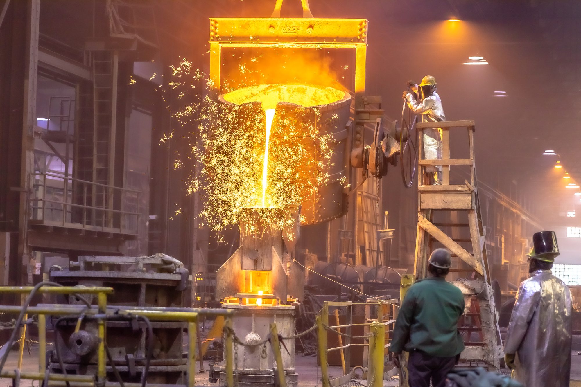 Sparks as molten metal pours from a ladle into a mold at United Rolls